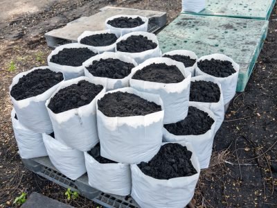 Prepare the soil for planting in a white bag. Prepare the Organic Soil bare soil garden. humus fertilizers, leaf fertilizers